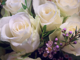 bouquet arrangement of white roses with small pink flowers