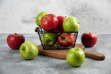 Fresh delicious green and red apples in metal basket