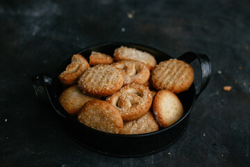 cookies in a metal plate on a dark background