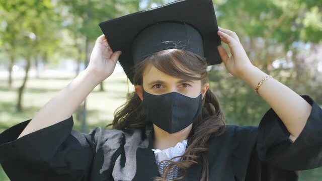 A female graduate student wearing a black medical mask during the coronavirus pandemic, portrait.