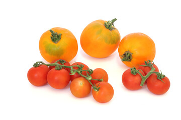 Yellow and red tomatoes isolated on white background