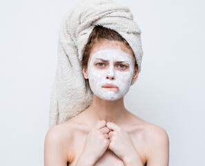 pretty woman with a towel on her head face mask naked shoulders attractive look