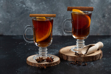 Two glass cups with fresh tea and cinnamon sticks