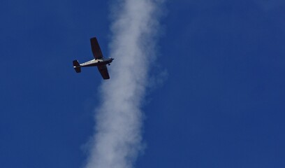 small plane with propellers flying in the blue sky. means of air transport