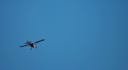 small plane with propellers flying in the blue sky. means of air transport
