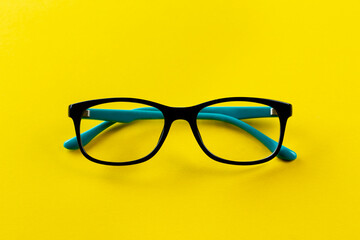 Stylish glasses for correcting vision on a yellow background.