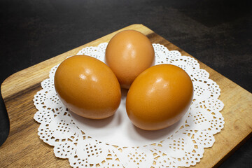closeup of organic eggs on black background