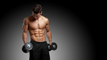 Fototapeta na wymiar Muscular with dumbbells pumping up muscles over black studio background, exercising with weights.