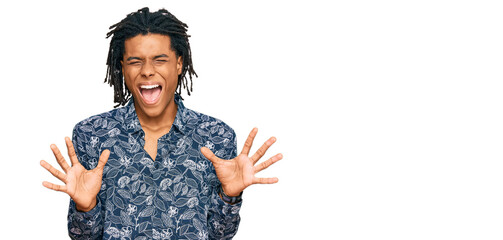 Young african american man wearing 80s shirt celebrating mad and crazy for success with arms raised...