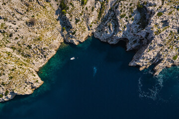Top view of rocky coastline with turquoise water.