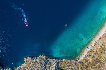 Top view of rocky coastline with turquoise water.