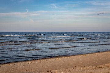 Fototapeta na wymiar beautiful miraculous seascape without people, Baltic sea Riga gulf, waves in evening sunset