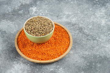 Red raw lentils and split peas on marble background