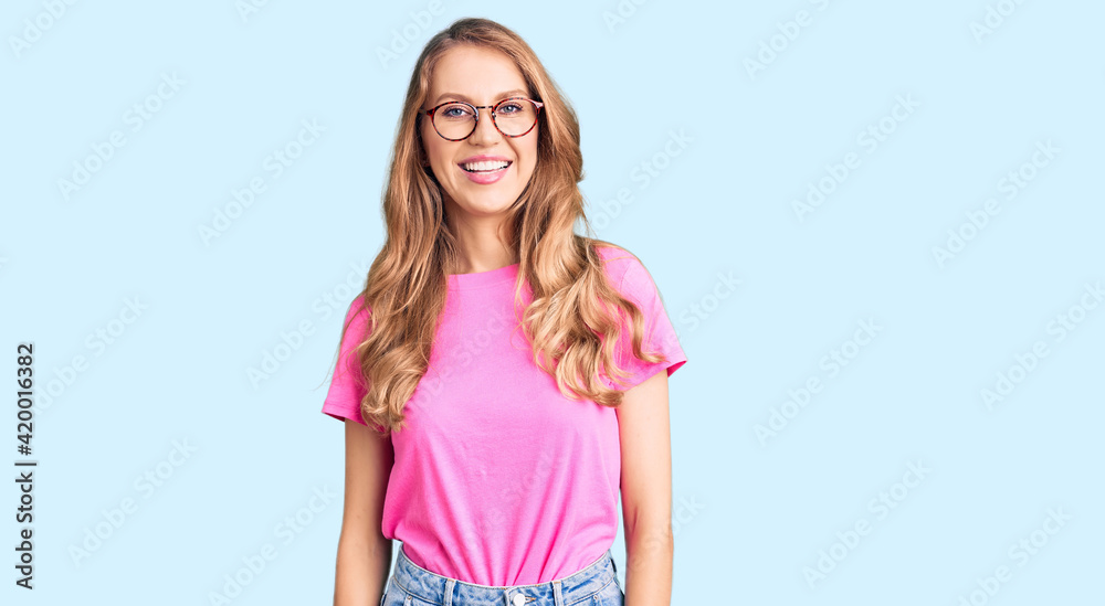 Canvas Prints young beautiful caucasian woman with blond hair wearing casual clothes and glasses with a happy and 