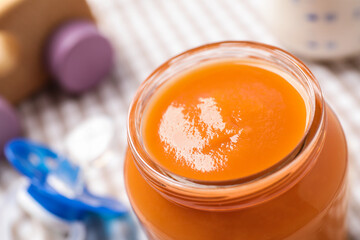 Healthy baby food in jar on table, closeup