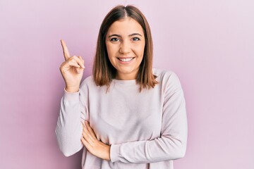 Young beautiful woman wearing casual clothes smiling happy pointing with hand and finger to the side