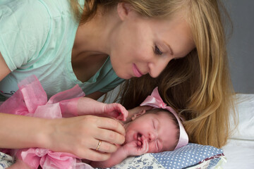 photo of a baby girl in a pink skirt and bow.