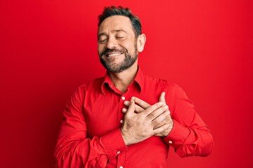 Middle age man wearing casual clothes smiling with hands on chest, eyes closed with grateful gesture on face. health concept.