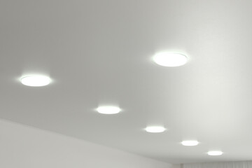White ceiling with lamps indoors, below view