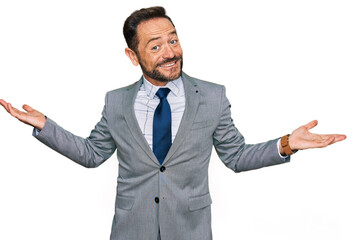 Middle age man wearing business clothes smiling showing both hands open palms, presenting and advertising comparison and balance