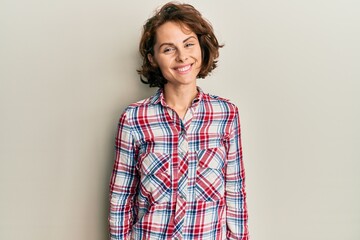 Young brunette woman wearing casual clothes with a happy and cool smile on face. lucky person.