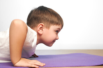 the child do physical activitythe.  boy is pushed off the floor