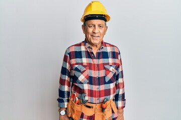 Senior hispanic man wearing handyman uniform with a happy and cool smile on face. lucky person.