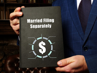 Financial concept meaning Married Filing Separately with phrase on the black notepad.