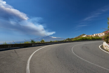 Fototapeta premium volcano in Sicily taken from the road that climbs to get to Taormina on a beautiful sunny day in spring 2021, you can see the station and Giardini Naxos with the whole