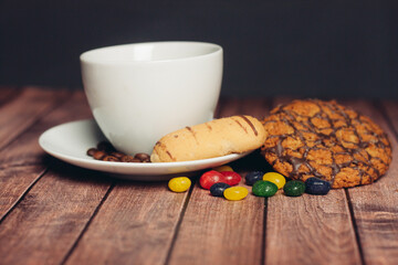 cookies on a plate a cup of tea on a wooden table