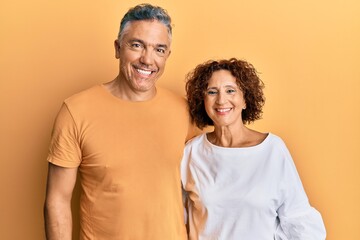 Obraz premium Beautiful middle age couple together wearing casual clothes with a happy and cool smile on face. lucky person.