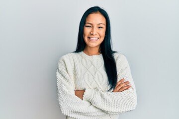 Beautiful hispanic woman wearing casual winter sweater over white background happy face smiling...