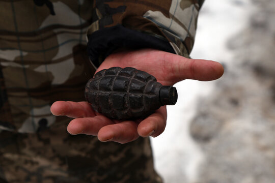 Russian hand grenade in soldier's hand