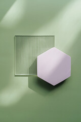 Ribbed acrylic plate and hexagon  on green background with  shadow. Stylish background for...