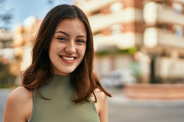 Young caucasian girl smiling happy standing at the city.