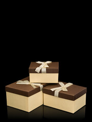 Three cardboard boxes for gifts with bows from silk tape