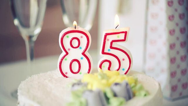 Birthday candle as number eighty five 85 on top of sweet cake on the table, 85th birthday, HD	