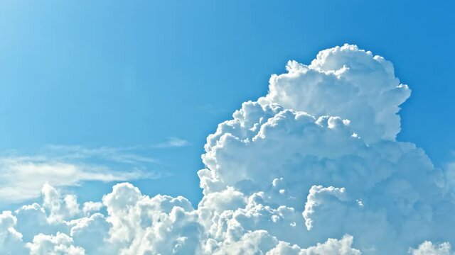 Timelapse of white cumulus clouds rolling in the blue sky with sunlight