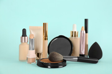 Foundation makeup products on turquoise background. Decorative cosmetics