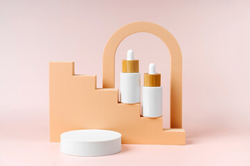 Obraz na płótnie Canvas White dropper bottles mockup on beige stairs with geometric shapes and podium. Background for branding and packaging presentation. Natural skincare beauty product concept.