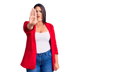 Young beautiful brunette woman wearing elegant clothes doing stop sing with palm of the hand....