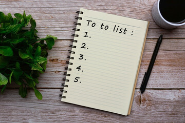 To do list text on notepad on wooden desk