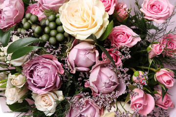 Beautiful bouquet with roses as background, closeup