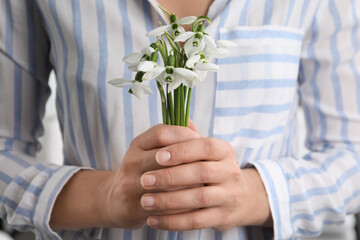 Woman holding beautiful bouquet of snowdrops, closeup