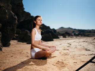 Fototapeta na wymiar Woman in swimsuit on the beach meditation outdoors island landscape