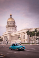 Fototapeta na wymiar Old car on streets of Havana with Capitolio building in background. Cuba