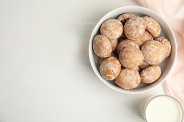 Tasty homemade gingerbread cookies and milk on white table, flat lay. Space for text