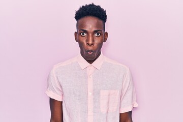Obraz premium Young african american man wearing casual clothes scared and amazed with open mouth for surprise, disbelief face