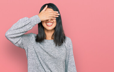 Beautiful asian young woman wearing casual clothes smiling and laughing with hand on face covering eyes for surprise. blind concept.