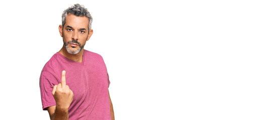 Middle age grey-haired man wearing casual clothes showing middle finger, impolite and rude fuck off...